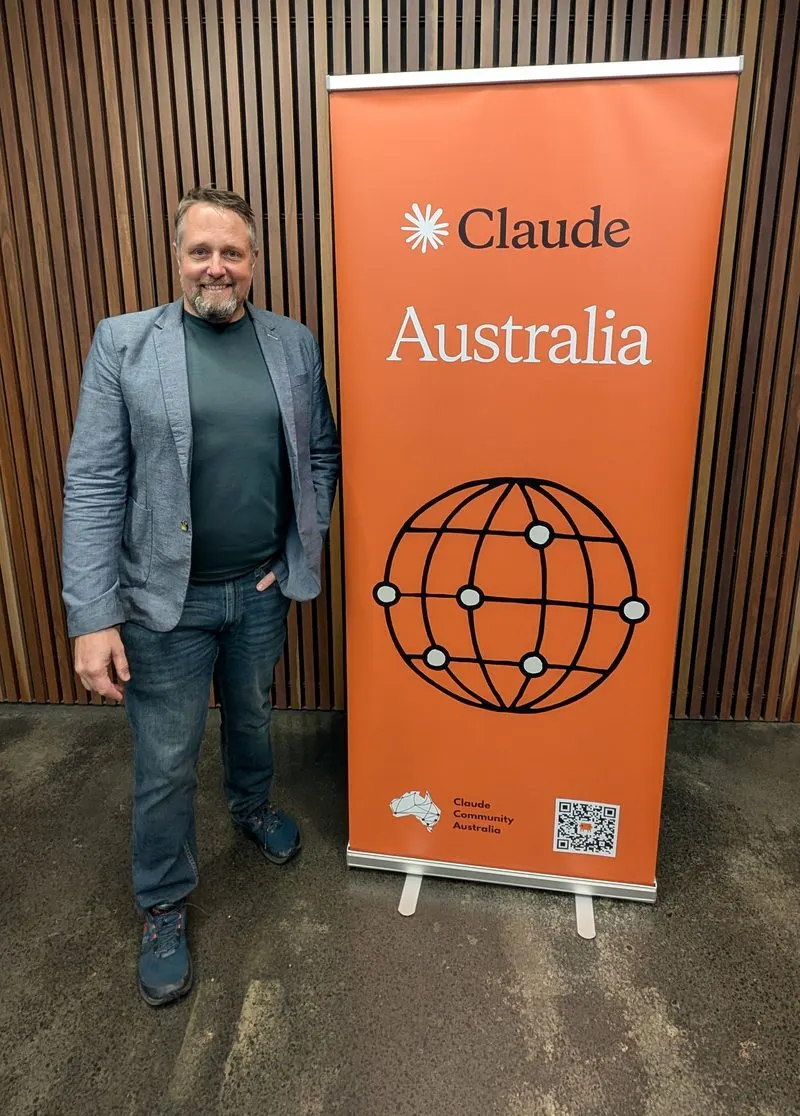 Dominik Fretz beside the Claude Australia banner